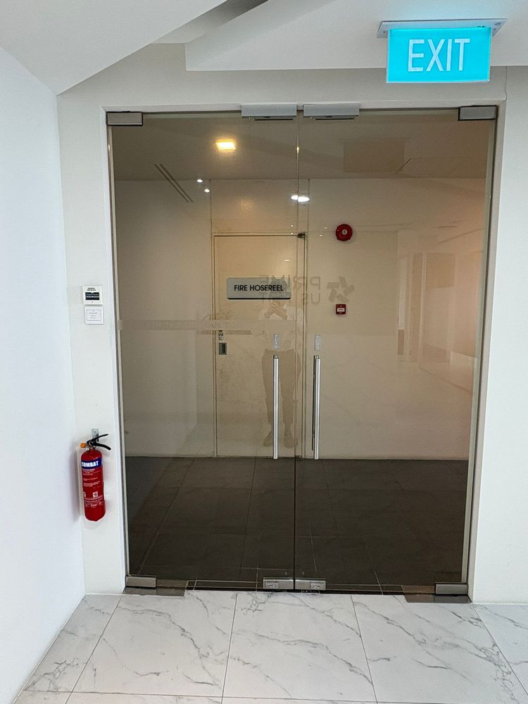 Commercial frameless glass door access control installation with professional EM lock bracket Singapore office