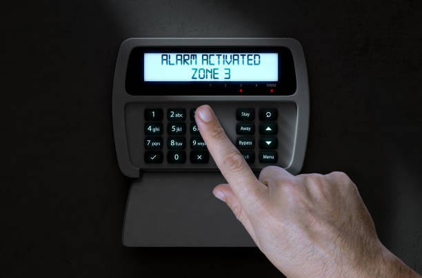 Hand activating office alarm system panel