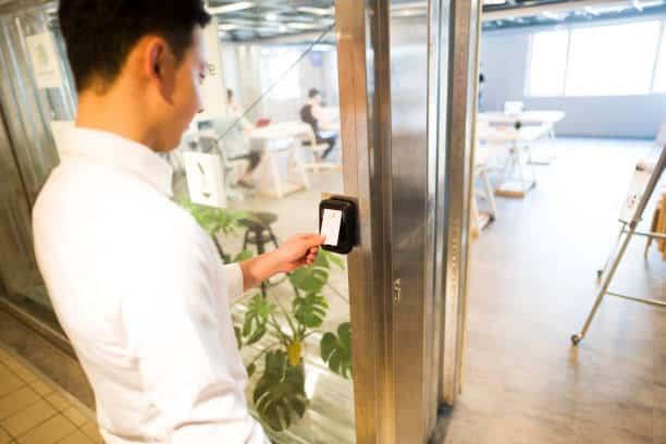 office worker using card on access control reader